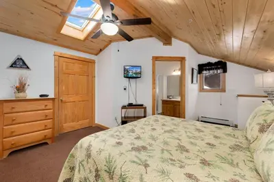 a bedroom with a bed and a ceiling fan at Bugle Pointe A03 by Estes Park Condos in Estes Park