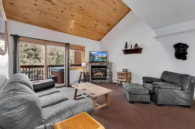 a living room with couches and a fireplace at Bugle Pointe A03 by Estes Park Condos in Estes Park