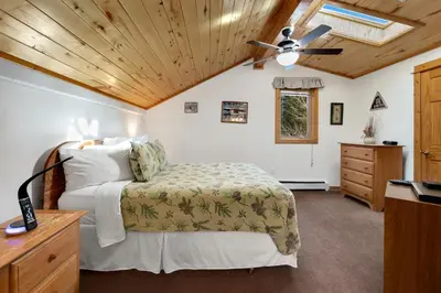a bedroom with a bed and a ceiling fan at Bugle Pointe A03 by Estes Park Condos in Estes Park