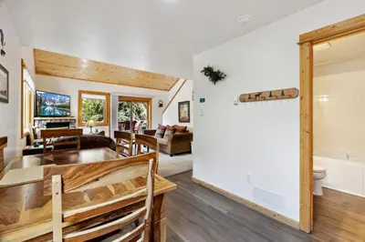 a living room and dining room with a table and chairs at Bugle Pointe A06 by Estes Park Condos in Estes Park