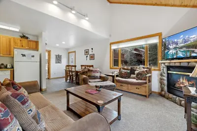 a living room with couches and a fireplace at Bugle Pointe A06 by Estes Park Condos in Estes Park