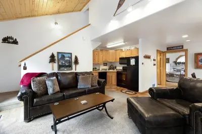 a living room with a couch and a table at Bugle Pointe A09 by Estes Park Condos in Estes Park