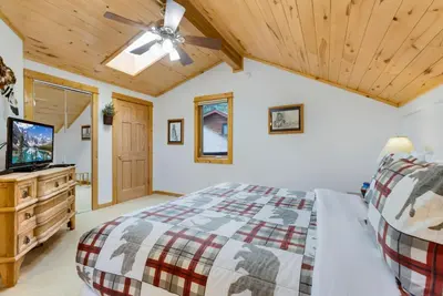 a bedroom with a bed and a ceiling fan at Bugle Pointe A09 by Estes Park Condos in Estes Park