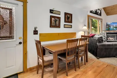 a dining room with a wooden table and chairs at Bugle Pointe A09 by Estes Park Condos in Estes Park
