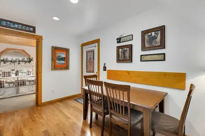 a dining room with a wooden table and chairs at Bugle Pointe A09 by Estes Park Condos in Estes Park