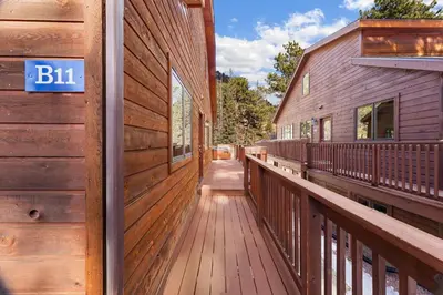 a wooden porch of a house with a sign on it at Bugle Pointe B11 by Estes Park Condos in Estes Park