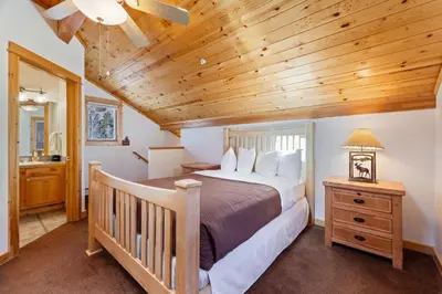 a bedroom with a bed and a wooden ceiling at Bugle Pointe B11 by Estes Park Condos in Estes Park