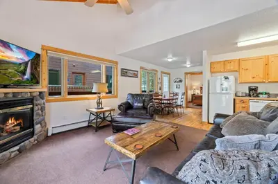 a living room with a couch and a fireplace at Bugle Pointe B11 by Estes Park Condos in Estes Park