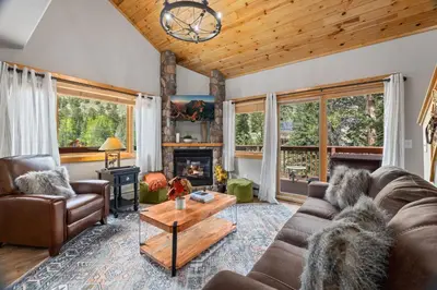 a living room with a couch and a table at Bugle Pointe B13 by Estes Park Condos in Estes Park