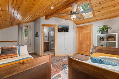 a bedroom with a bed and a ceiling fan at Bugle Pointe B13 by Estes Park Condos in Estes Park