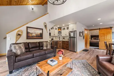 a living room with a couch and a table at Bugle Pointe B13 by Estes Park Condos in Estes Park