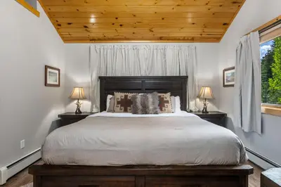 a bedroom with a large bed and two lamps at Bugle Pointe B13 by Estes Park Condos in Estes Park
