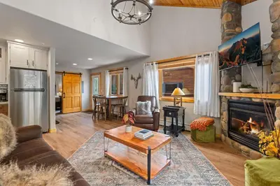 a living room with a couch and a fireplace at Bugle Pointe B13 by Estes Park Condos in Estes Park