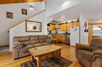 a living room with two couches and a table at Bugle Pointe B21 by Estes Park Condos in Estes Park