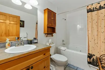 a bathroom with a sink and a toilet and a tub at Bugle Pointe B21 by Estes Park Condos in Estes Park