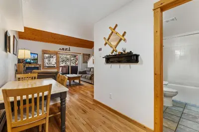 a dining room and living room with a table and chairs at Bugle Pointe B21 by Estes Park Condos in Estes Park