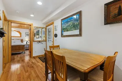 a dining room with a wooden table and chairs at Bugle Pointe B21 by Estes Park Condos in Estes Park