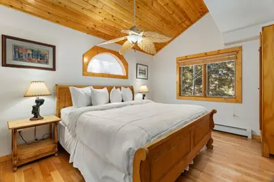 a bedroom with a bed and a ceiling fan at Bugle Pointe B21 by Estes Park Condos in Estes Park
