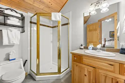a bathroom with a shower and a toilet and a sink at Creekside Condos D by Estes Park Condos in Estes Park