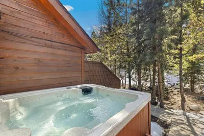 a jacuzzi tub in the side of a house at Creekside Condos D by Estes Park Condos in Estes Park