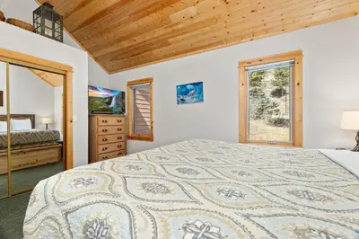 a bedroom with a large bed and a window at Creekside Condos D by Estes Park Condos in Estes Park