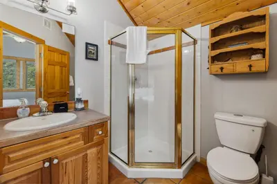 a bathroom with a shower and a toilet and a sink at Creekside Condos H by Estes Park Condos in Estes Park