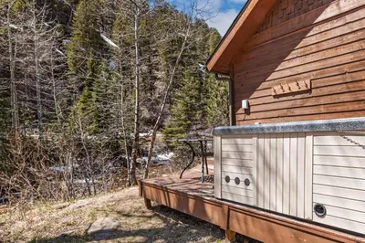 a deck on the side of a cabin at Creekside Condos H by Estes Park Condos in Estes Park