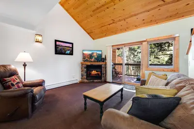 a living room with a couch and chairs and a fireplace at Bugle Pointe B15 by Estes Park Condos in Estes Park