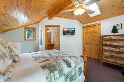 a bedroom with a bed and a ceiling fan at Bugle Pointe B15 by Estes Park Condos in Estes Park