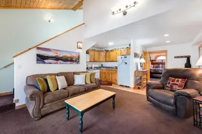 a living room with a couch and a table at Bugle Pointe B15 by Estes Park Condos in Estes Park