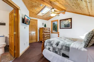 a bedroom with a bed and a ceiling fan at Bugle Pointe B15 by Estes Park Condos in Estes Park