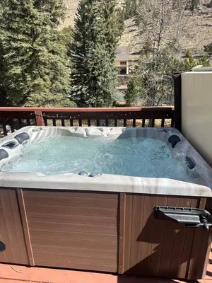 a jacuzzi tub sitting on a deck at Bugle Pointe A04 by Estes Park Condos in Estes Park
