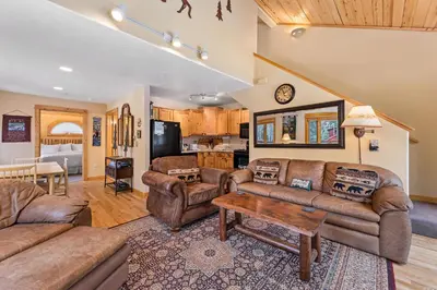 a living room with couches and a table at Bugle Pointe A04 by Estes Park Condos in Estes Park
