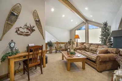 a living room with a couch and a table at Elk River Cabin -- Cabin Condo in Estes Park -- 23-ZONE3554 condo in Estes Park