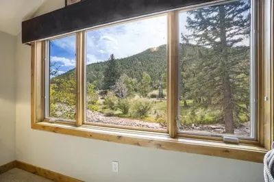 a window with a view of a mountain at Elk River Cabin -- Cabin Condo in Estes Park -- 23-ZONE3554 condo in Estes Park