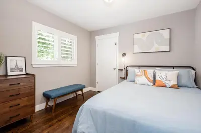 a bedroom with a bed and a dresser and a window at Mid-Mod Marvel Central Game RmWet Bar Patio in Arvada