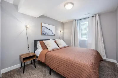 a bedroom with a bed and a window at Mid-Mod Marvel Central Game RmWet Bar Patio in Arvada