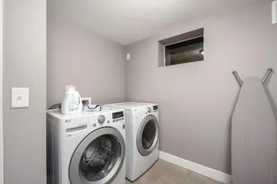 a laundry room with a washing machine in it at Mid-Mod Marvel Central Game RmWet Bar Patio in Arvada
