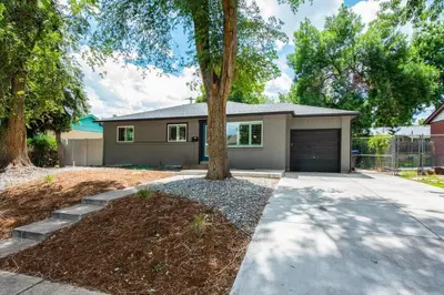 a house with a tree and a driveway at Mid-Mod Marvel Central Game RmWet Bar Patio in Arvada