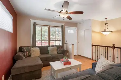a living room with a couch and a ceiling fan at Arvada home w hot tub & BBQ in Arvada