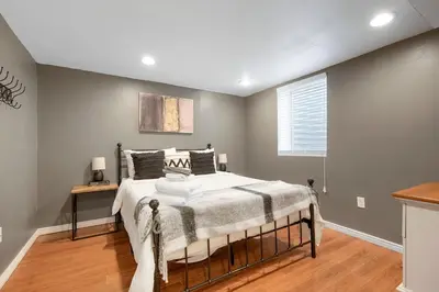 a bedroom with a bed and a window at Arvada home w hot tub & BBQ in Arvada