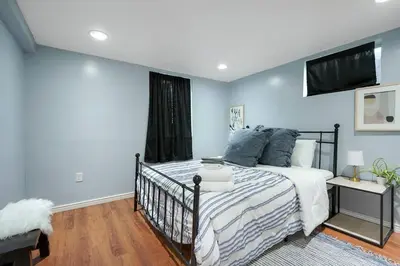 a bedroom with a bed with blue walls at Arvada home w hot tub & BBQ in Arvada