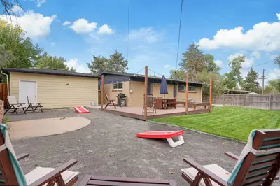 a backyard with a house with a playground at Arvada home w hot tub & BBQ in Arvada