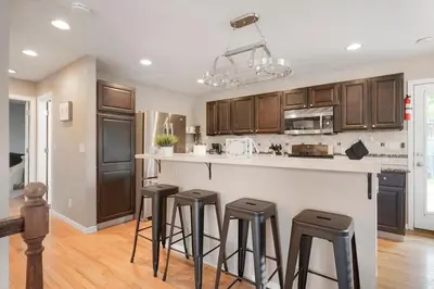 a kitchen with a counter and stools in a room at Arvada home w hot tub & BBQ in Arvada