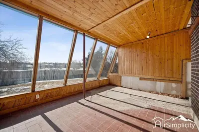 an empty room with wood paneled walls and windows at Spacious home w game room & firepit in Arvada