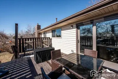 a deck with chairs and a table on a house at Spacious home w game room & firepit in Arvada