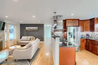 a kitchen and living room with a couch and a refrigerator at Group-Friendly 4-Bedroom Denver Home w Backyard in Centennial