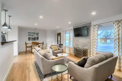 a living room with two couches and a fireplace at Group-Friendly 4-Bedroom Denver Home w Backyard in Centennial