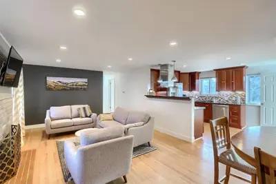 a living room with a couch and a table at Group-Friendly 4-Bedroom Denver Home w Backyard in Centennial
