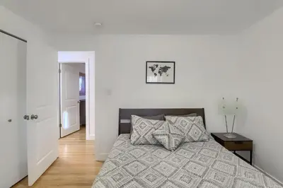 a bedroom with a bed with a gray comforter at Group-Friendly 4-Bedroom Denver Home w Backyard in Centennial